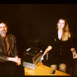 Charles Amirkhanian and Susan Stone, seated onstage with a tape deck during Speaking of Music at the Exploratorium, v.2 (1991)
