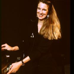 Three quarter length portrait of Susan Stone onstage facing forward during Speaking of Music at the Exploratorium, v2. 2 (1991)
