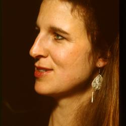 A head and shoulders portrait of Susan Stone, looking left, during Speaking of Music at the Exploratorium (1991)