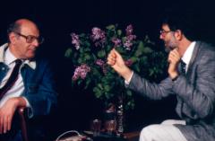 Half length portrait of Mauricio Kagel and Charles Amirkhanian in conversation during Speaking of Music at the Exploratorium, San Francisco (1988)