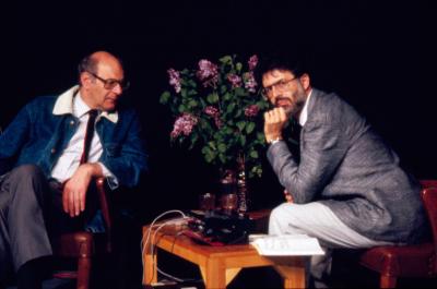 Portrait of Mauricio Kagel and Charles Amirkhanian seated onstage during Speaking of Music at the Exploratorium, San Francisco (1988)