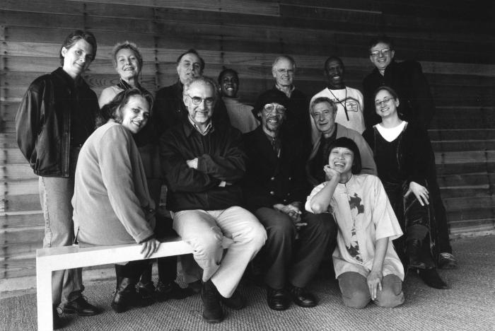 Featured participants and organizers of OM 5, standing and seated, facing forward, Woodside, 1999 (cropped image)