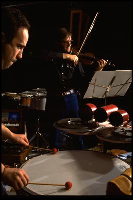 William Winant, with David Rosenboom, half length portrait, performing at the Exploratorium