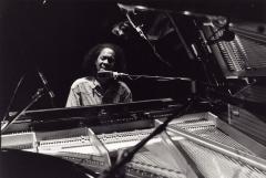 Head and shoulders portrait of Errollyn Wallen performing at the piano, San Francisco (cropped image)
