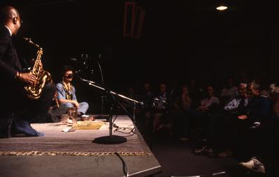 John Handy, kneeling on stage during Speaking of Music, San Francisco (198?)