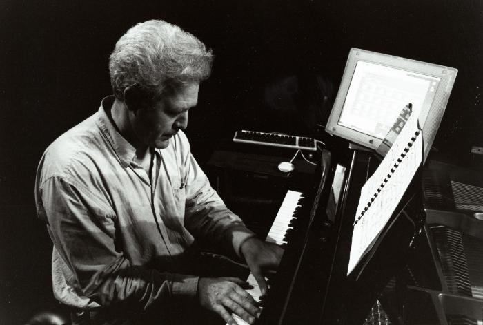 Chris Brown, half length portrait, seated, facing right & slightly down, playing the piano, San Francisco, (2001)