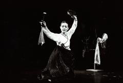 Eun-ha Park, full length portrait, facing forward, performing a dance with percussion, San Francisco, 2001 (cropped image)