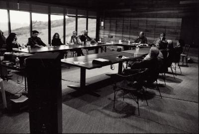 Group portrait of OM 9 participants seated around a table during private discussions, Woodside, 2003 (cropped image)