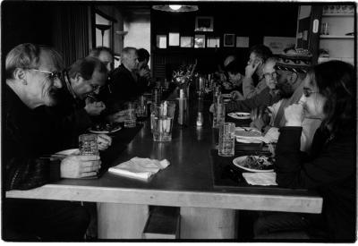 Some of the featured OM 9 participants, seated, having a meal, Woodside, 2003 (cropped image)