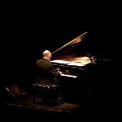 Michael Nyman, full length portrait, seated at piano, back to camera, facing slightly right, ver. 2, San Francisco, CA., (2005)