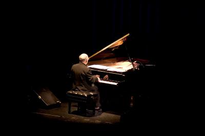 Michael Nyman, full length portrait, seated at piano, back to camera, facing slightly right, ver. 1, San Francisco, CA., (2005)