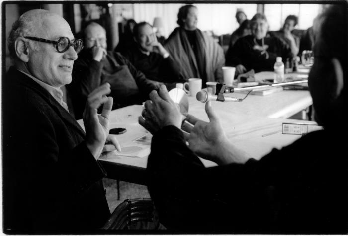 Michael Nyman, looking right and gesturing as Charles Amirkhanian holds a compact disc and other OM 11 participants look on, Woodside, CA (2005)