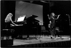 Sarah Cahill, on piano, and Amy X Neuburg, standing, singing, onstage during the 11th Other Minds Festival, San Francisco, CA (2005)