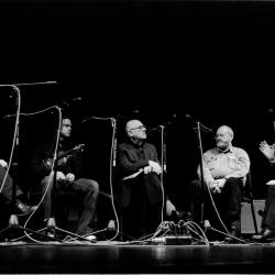Seth Josel, Daniel Bernard Roumain, Michael Nyman, and Phil Niblock seated onstage with Charles Amirkhanian for a panel discussion during the 11th Other Minds Festival, San Francisco, CA (2005)