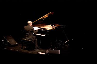 Michael Nyman, full length portrait, seated at piano, back to camera, facing slightly right, ver. 3, San Francisco, CA., (2005)