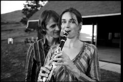 Head and shoulders portrait of Markus Stockhausen, standing behind Tara Bouman as she plays the clarinet, Woodside CA, 2006