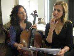 Gianna Abondolo & Linda Catlin Smith (l to r), half length portrait, seated, consulting a score, San Francisco CA., (2009)