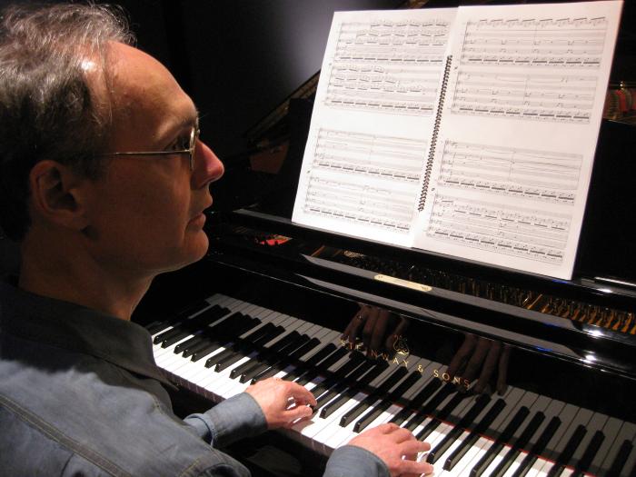 Michael Harrison, head and shoulders portrait, seated, playing piano, facing right, ver 2.