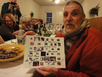 Anthony Gnazzo, sitting and holding a card during his 75th birthday (2011)