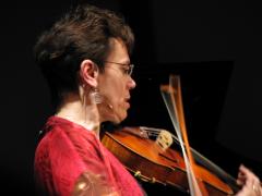 Susan Ung, head and shoulders portrait, facing right, playing the viola, San Francisco