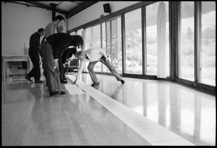 Jürg Frey (far right), bending down, displays a musical score for the perusal of his fellow OM 15 composers, Woodside CA., vs 2 (2010)