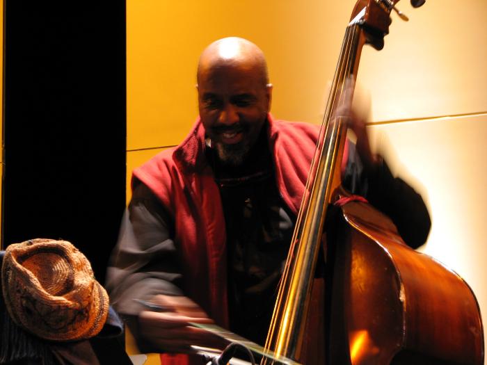 William Parker, half length portrait, facing forward, playing the stringed bass at OM 15