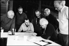 OM 15 composers and organizers gathered around a table while Tom Johnson points over a score, Woodside CA., (2010) 