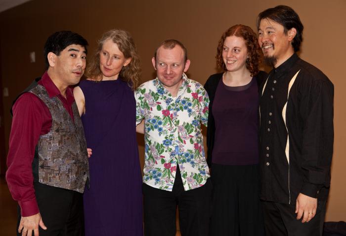 Rick Shinozaki, looking forward, with Kate Stenberg,  Paweł Mykietyn, Hannah Addario-Berry, & Charlton Lee, all looking at Rick, (l to r), three quarter length portrait, San Francisco CA., (2010)