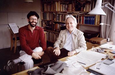 Charles Amirkhanian with György Ligeti, seated, at a desk with a musical score