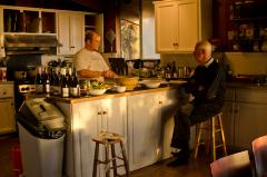 Han Bennink seated at a counter, talking with chef of the Djerassi Resident Artists Program, Woodside CA (2011)