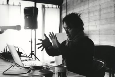 Ken Ueno, seated and talking during his presentation at the Djerassi Resident Artists Program, Woodside CA (2012)