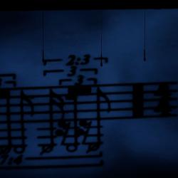 Projection image of musical notation during performance of "Half a Bit of Nothing Integrated, for amplified objects, and live video" by Simon Steen-Anderson, OM 17