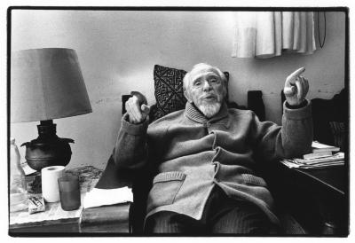 Conlon Nancarrow seated and reclining in a chair at his home studio, Mexico, 1990