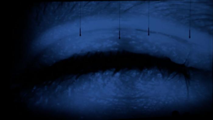 Projection image of an eye lid during performance of "Half a Bit of Nothing Integrated, for amplified objects, and live video" by Simon Steen-Anderson, OM 17