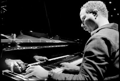 Craig Taborn, seated and playing piano during a rehearsal prior to OM 18