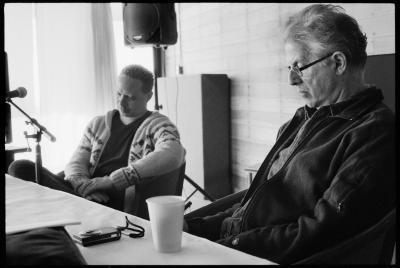 Half length portrait of Craig Taborn and Charles Amirkhanian seated during Taborn's presentation to fellow artists at the Djerassi Resident Artists Program, Woodside CA (2013)