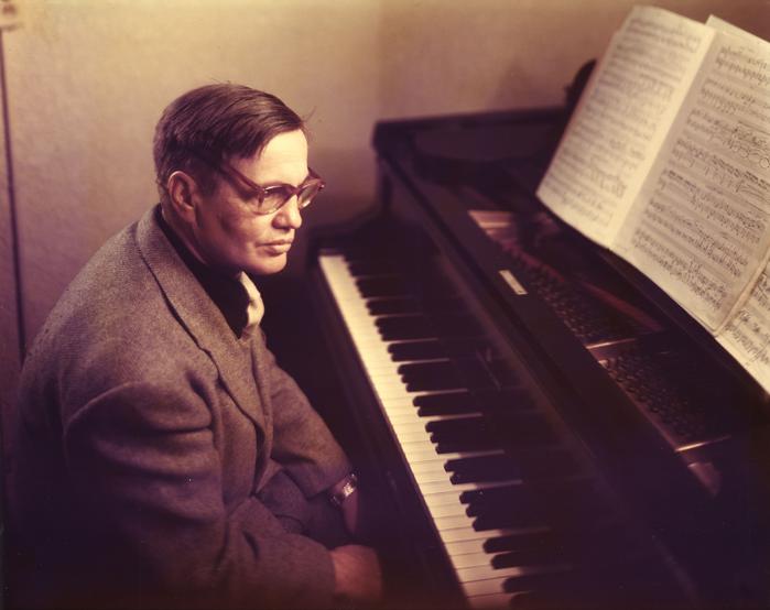 Portrait of an older George Antheil, seated at the piano