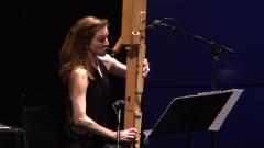 Anna Petrini seated onstage with her Paetzold contrabass recorder during the second concert of OM 18, vs. 4, San Francisco CA (2013)