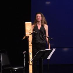 Anna Petrini standing onstage with her Paetzold contrabass recorder after a performance during the second concert of OM 18, San Francisco CA (2013)