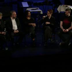 Panel discussion participants seated onstage prior to the third concert of OM 18, San Francisco CA (2013)