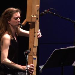 Anna Petrini seated onstage with her Paetzold contrabass recorder during the second concert of OM 18, vs. 6, San Francisco CA (2013)