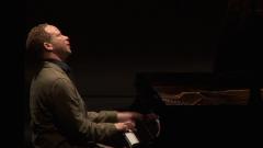 Craig Taborn seated onstage at the piano during the second concert of OM 18, San Francisco CA (2013)