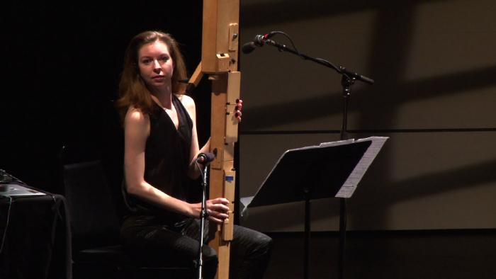 Anna Petrini seated onstage with her Paetzold contrabass recorder during the second concert of OM 18, vs. 3, San Francisco CA (2013)