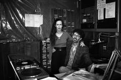 Meredith Monk standing next to a seated Charles Amirkhanian in the KPFA studios, 1988