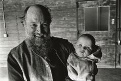 Terry Riley holding grandchild, head and shoulders portrait, facing forward, Woodside CA, (1995)