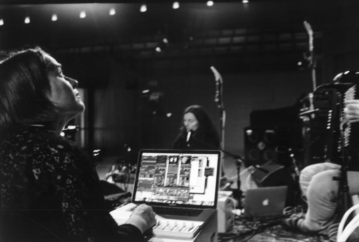 Kathy Hinde looking up at her projections during a performance at OM 20, San Francisco CA (2015)