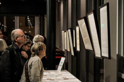 OM 20 attendees observing scores on display for the silent auction, San Francisco CA (2015)