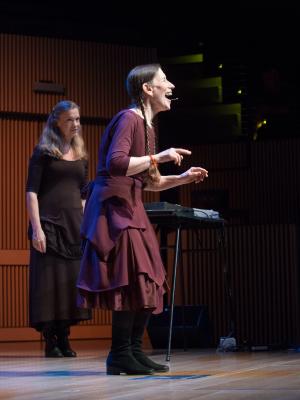 Meredith Monk singing while Katie Geissinger stands by during the third concert of OM 21, San Francisco CA (2016)