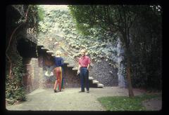 Carol Law (back to camera) and Conlon Nancarrow outside in Nancarrow's yard, 1969