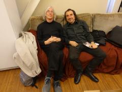 Jaap Blonk and Enzo Minarelli seated on a couch prior to performances at OM 23, San Francisco CA (April 9, 2018)